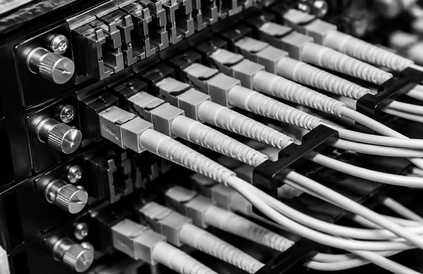 Close-up of network patch panel cabling in black and white